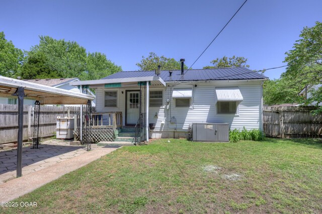 430 N Jackson Ave, Joplin, MO 64801 - back of property with central AC unit, a patio area, and metal roof