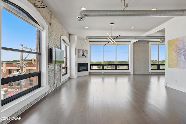 214 E 4th St Unit 402, Joplin, MO 64801 - unfurnished living room with a fireplace and wood finished floors