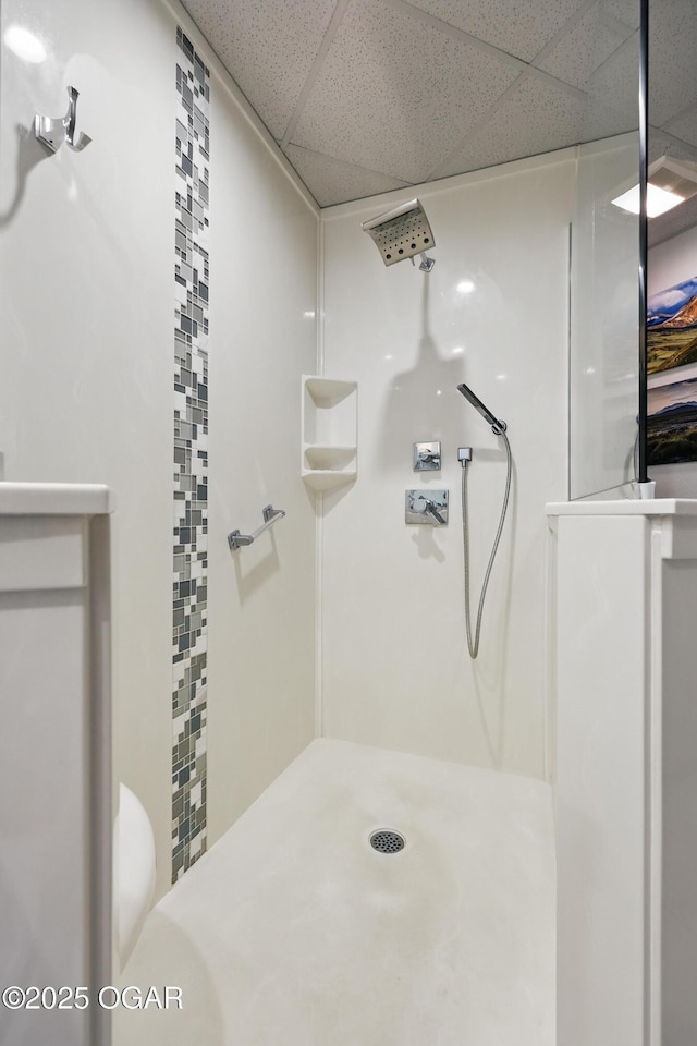 214 E 4th St Unit 402, Joplin, MO 64801 - bathroom featuring a drop ceiling, a shower, and toilet