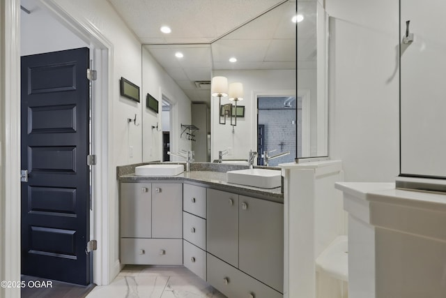 214 E 4th St Unit 402, Joplin, MO 64801 - full bathroom featuring marble finish flooring, double vanity, recessed lighting, and a paneled ceiling