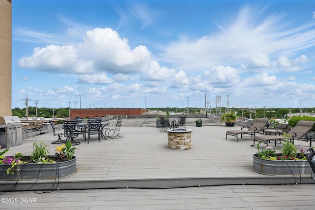 214 E 4th St Unit 402, Joplin, MO 64801 - wooden deck with outdoor dining space, a grill, and a fire pit