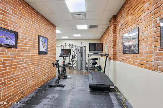 214 E 4th St Unit 402, Joplin, MO 64801 - workout area featuring a drop ceiling, brick wall, and baseboards