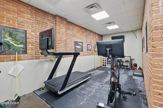 214 E 4th St Unit 402, Joplin, MO 64801 - exercise room featuring a drop ceiling and brick wall