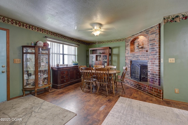 610 N Madison St, Webb City, MO 64870 - dining room with a fireplace, a ceiling fan, wood finished floors, a textured ceiling, and baseboards