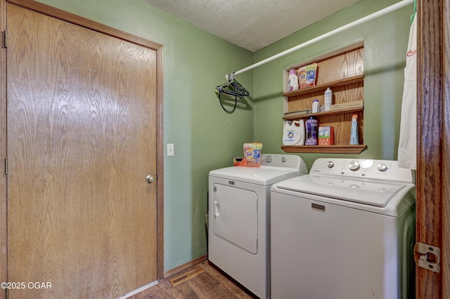 610 N Madison St, Webb City, MO 64870 - laundry area with washing machine and clothes dryer, wood finished floors, and a textured ceiling