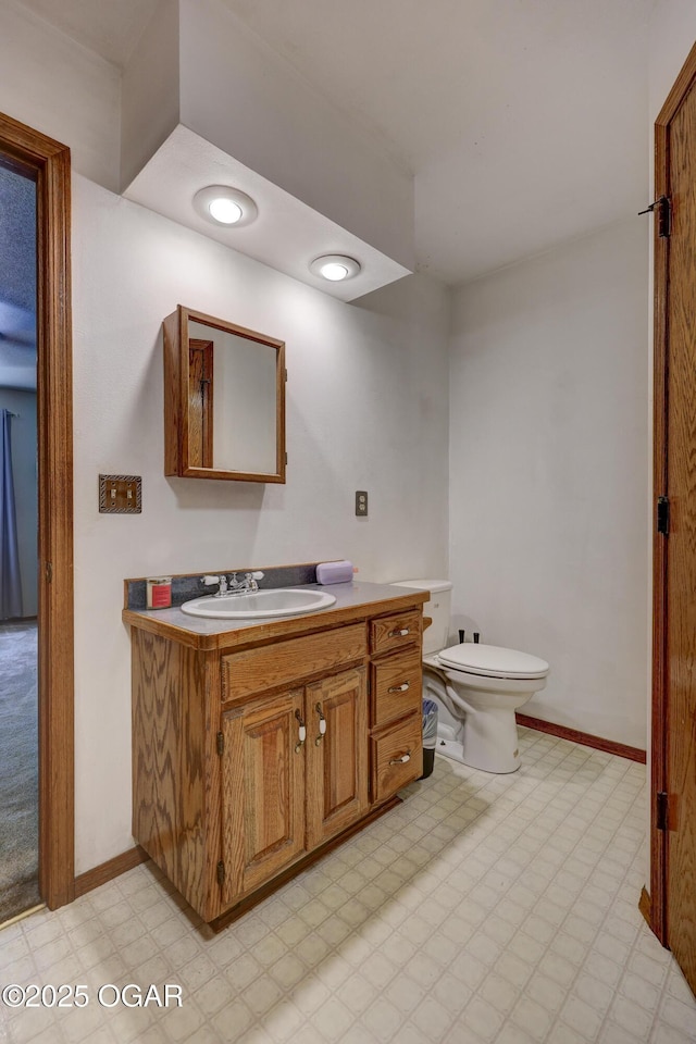 610 N Madison St, Webb City, MO 64870 - half bathroom featuring vanity, tile patterned floors, toilet, and baseboards
