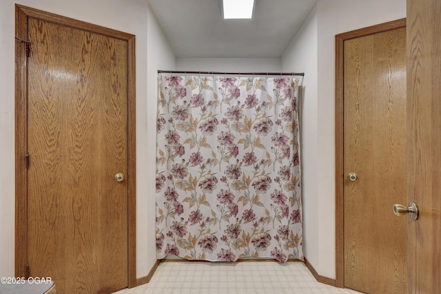 610 N Madison St, Webb City, MO 64870 - bathroom with tile patterned floors, curtained shower, and baseboards