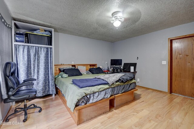 610 N Madison St, Webb City, MO 64870 - bedroom with a textured ceiling, wood finished floors, and a desk