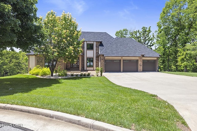 3802 Fawn Trl, Joplin, MO 64804 - view of front facade featuring a garage, concrete driveway, a front lawn, and brick siding
