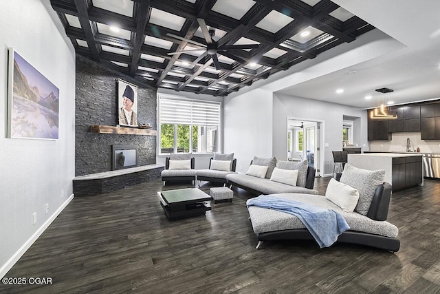 3802 Fawn Trl, Joplin, MO 64804 - living area featuring coffered ceiling, baseboards, dark wood-type flooring, a stone fireplace, and recessed lighting