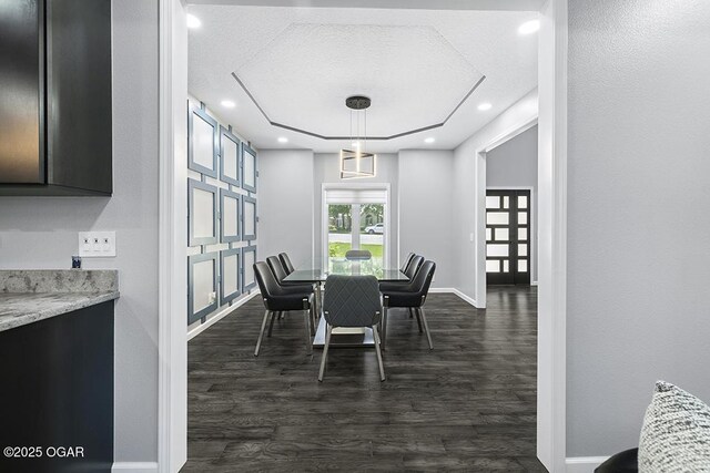 3802 Fawn Trl, Joplin, MO 64804 - dining area featuring dark wood finished floors, baseboards, a raised ceiling, a textured ceiling, and recessed lighting