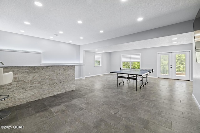 3802 Fawn Trl, Joplin, MO 64804 - rec room with a textured ceiling, recessed lighting, baseboards, and french doors