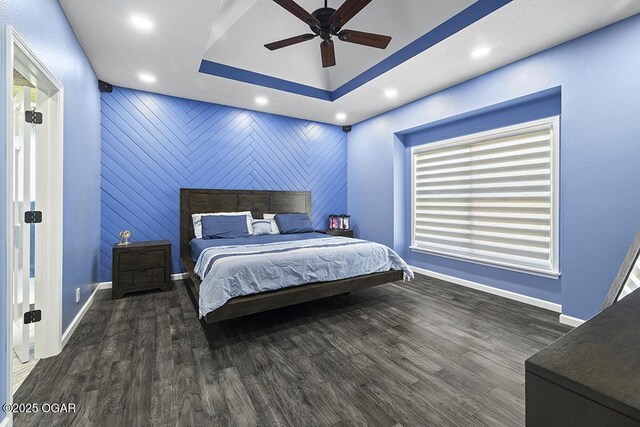 3802 Fawn Trl, Joplin, MO 64804 - bedroom with baseboards, recessed lighting, wood finished floors, an accent wall, and a tray ceiling