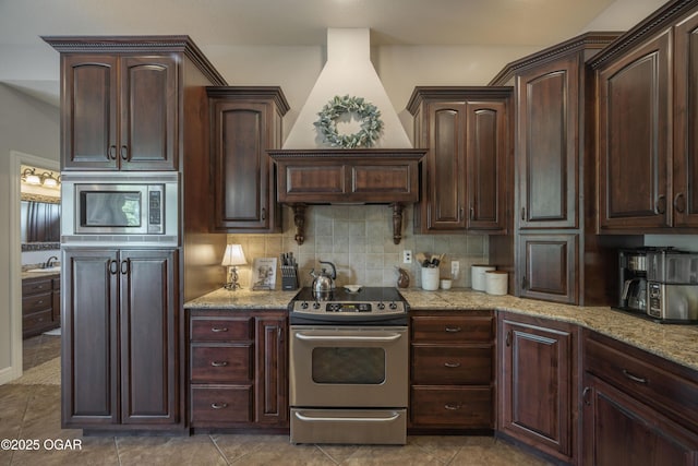 20951 Jasmine Ln, Webb City, MO 64870 - kitchen featuring appliances with stainless steel finishes, decorative backsplash, light stone counters, and a sink
