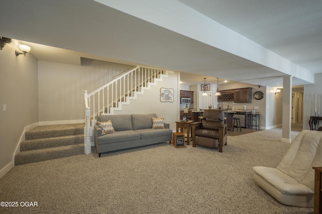 20951 Jasmine Ln, Webb City, MO 64870 - living area featuring stairway, carpet floors, wet bar, and baseboards