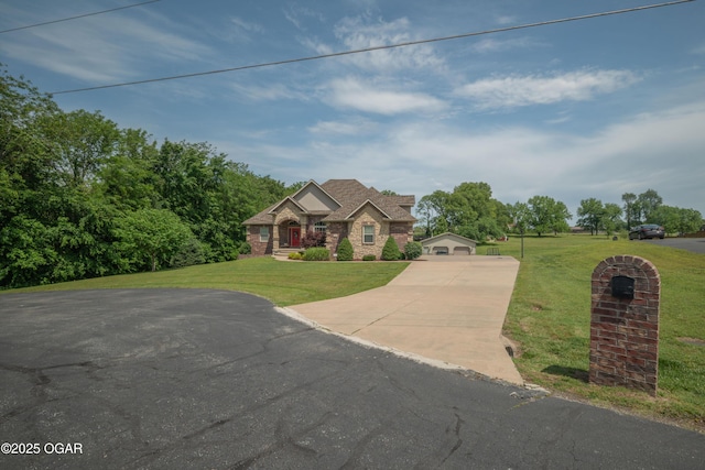 20951 Jasmine Ln, Webb City, MO 64870 - view of front of home with a front yard, driveway, and stone siding