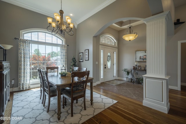 20951 Jasmine Ln, Webb City, MO 64870 - dining space with crown molding, arched walkways, wood finished floors, a high ceiling, and baseboards