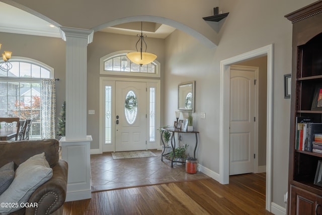 20951 Jasmine Ln, Webb City, MO 64870 - foyer with decorative columns, baseboards, wood finished floors, a high ceiling, and arched walkways