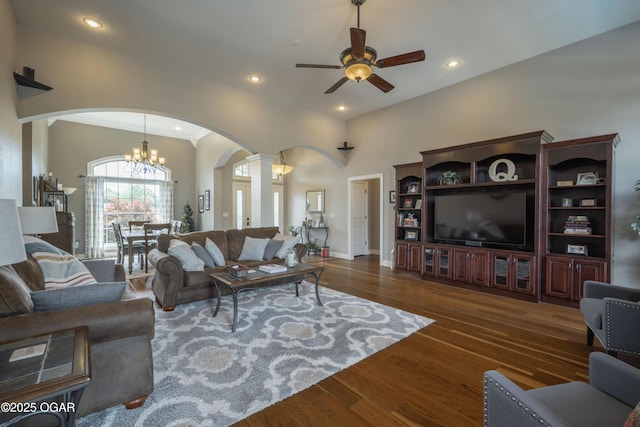 20951 Jasmine Ln, Webb City, MO 64870 - living area featuring arched walkways, ceiling fan, a chandelier, ornate columns, and wood finished floors