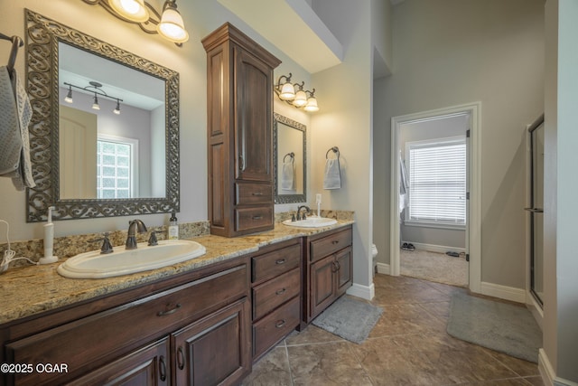 20951 Jasmine Ln, Webb City, MO 64870 - full bath with double vanity, baseboards, toilet, tile patterned flooring, and a shower with door