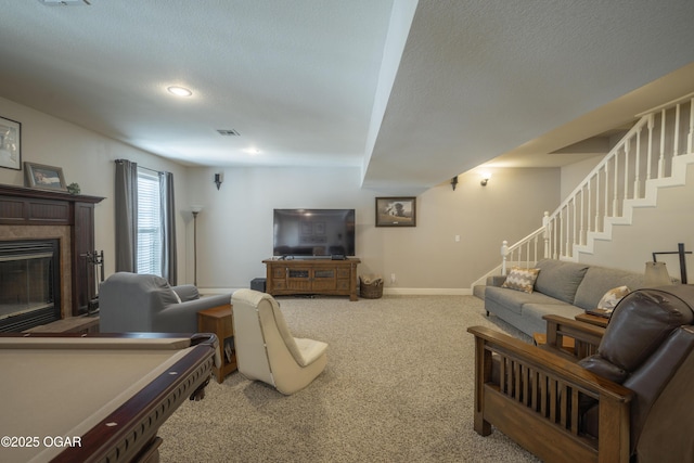 20951 Jasmine Ln, Webb City, MO 64870 - living area with stairway, carpet flooring, a glass covered fireplace, baseboards, and recessed lighting