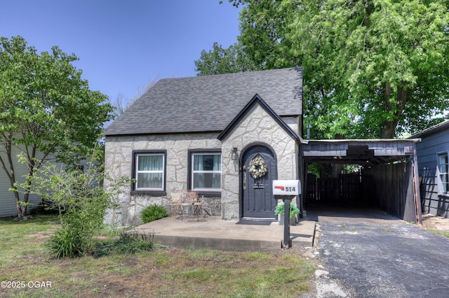 514 S Brownell Ave, Joplin, MO 64801 - tudor-style house featuring driveway and roof with shingles