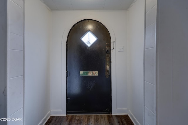 514 S Brownell Ave, Joplin, MO 64801 - entrance foyer with arched walkways, dark wood finished floors, baseboards, and ornamental molding