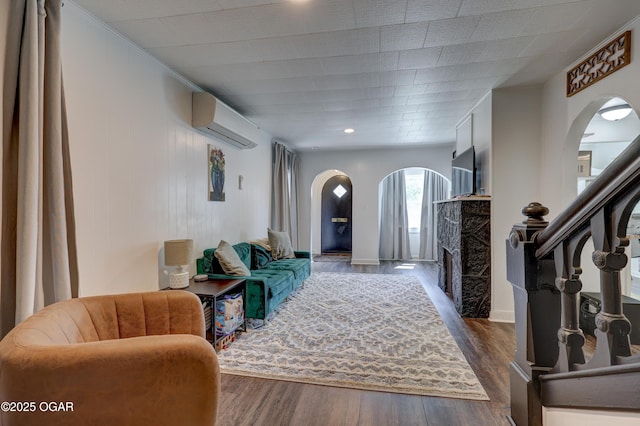 514 S Brownell Ave, Joplin, MO 64801 - entryway featuring a wall mounted air conditioner, arched walkways, a fireplace, and dark wood-style floors