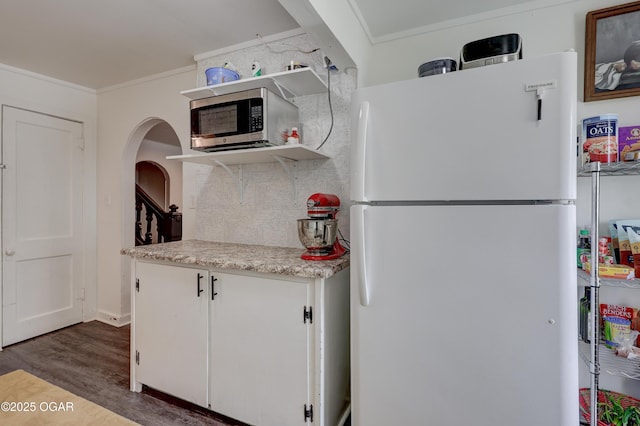 514 S Brownell Ave, Joplin, MO 64801 - kitchen featuring freestanding refrigerator, stainless steel microwave, wood finished floors, crown molding, and light countertops