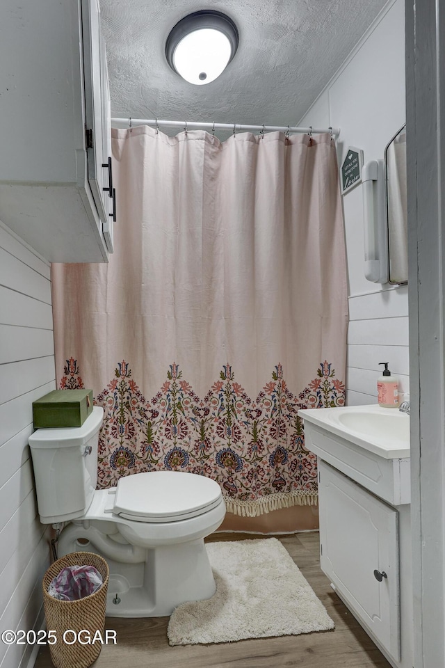 514 S Brownell Ave, Joplin, MO 64801 - bathroom featuring toilet, wood finished floors, vanity, a textured ceiling, and a shower with shower curtain