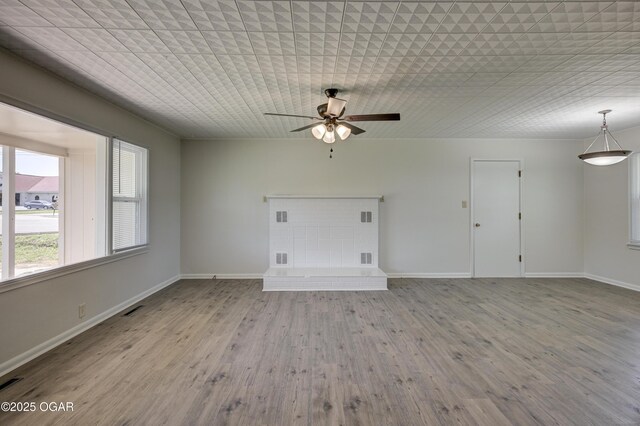 3124 Missouri Ave, Joplin, MO 64804 - unfurnished living room with ceiling fan, wood finished floors, and baseboards