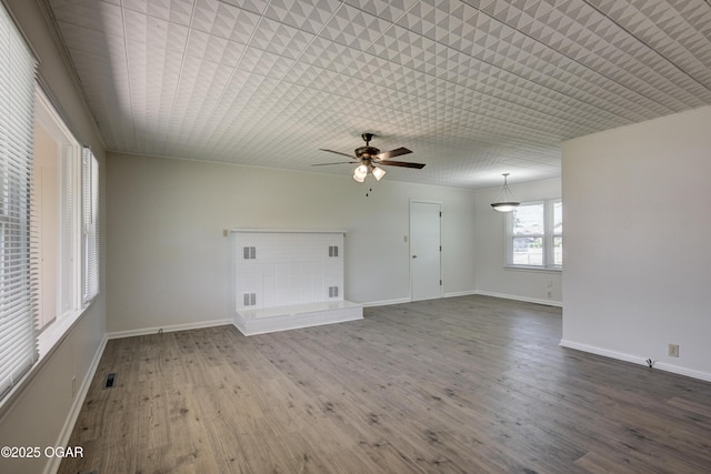 3124 Missouri Ave, Joplin, MO 64804 - unfurnished living room with ceiling fan, wood finished floors, and baseboards