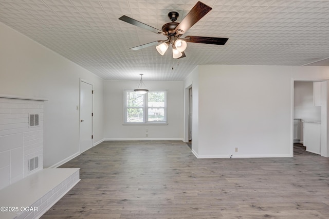 3124 Missouri Ave, Joplin, MO 64804 - unfurnished living room with ceiling fan, wood finished floors, and baseboards