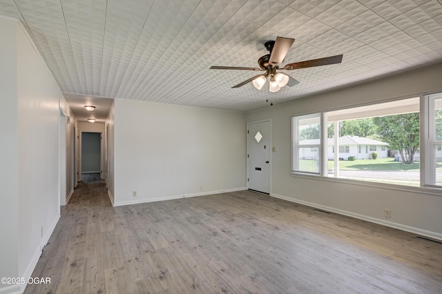 3124 Missouri Ave, Joplin, MO 64804 - unfurnished living room featuring a ceiling fan, wood finished floors, and baseboards