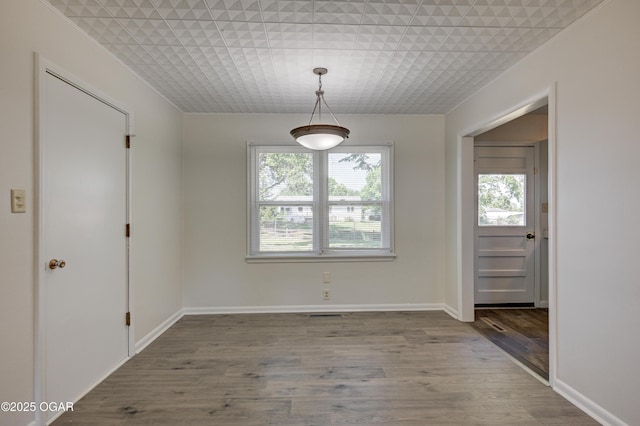 3124 Missouri Ave, Joplin, MO 64804 - unfurnished dining area featuring wood finished floors and baseboards