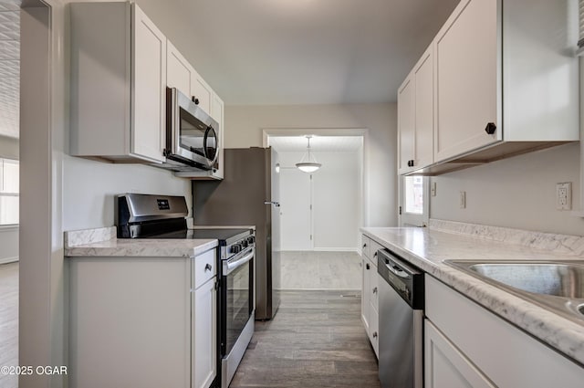 3124 Missouri Ave, Joplin, MO 64804 - kitchen with stainless steel appliances, dark wood-style flooring, light countertops, and white cabinetry