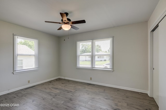 3124 Missouri Ave, Joplin, MO 64804 - unfurnished bedroom with wood finished floors, a closet, baseboards, and a ceiling fan