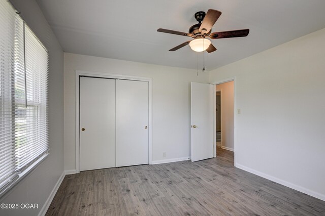 3124 Missouri Ave, Joplin, MO 64804 - unfurnished bedroom featuring wood finished floors, a closet, baseboards, and ceiling fan