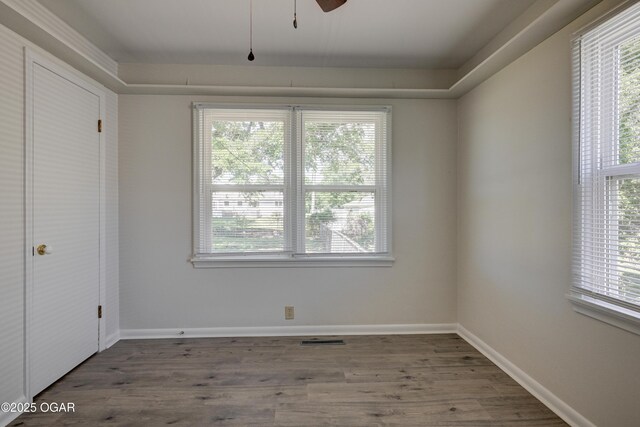 3124 Missouri Ave, Joplin, MO 64804 - unfurnished bedroom featuring multiple windows, wood finished floors, and baseboards