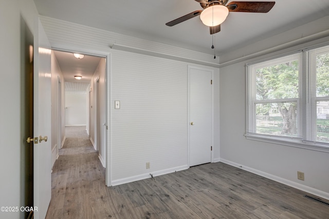 3124 Missouri Ave, Joplin, MO 64804 - unfurnished bedroom with baseboards, wood finished floors, multiple windows, and a closet