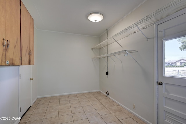 3124 Missouri Ave, Joplin, MO 64804 - laundry area with ornamental molding, baseboards, and light tile patterned flooring