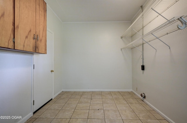 3124 Missouri Ave, Joplin, MO 64804 - washroom featuring cabinet space, crown molding, baseboards, and light tile patterned floors