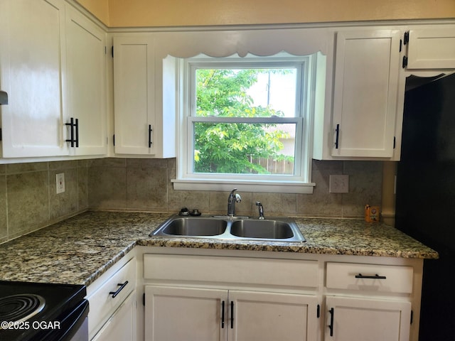2432 S Florida, Joplin, MO 64804 - kitchen featuring a sink, freestanding refrigerator, tasteful backsplash, and white cabinets