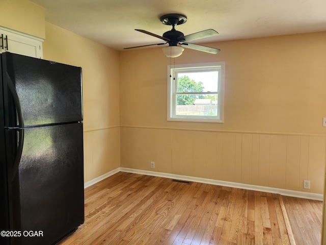 2432 S Florida, Joplin, MO 64804 - unfurnished room featuring light wood-style floors, ceiling fan, baseboards, and wainscoting