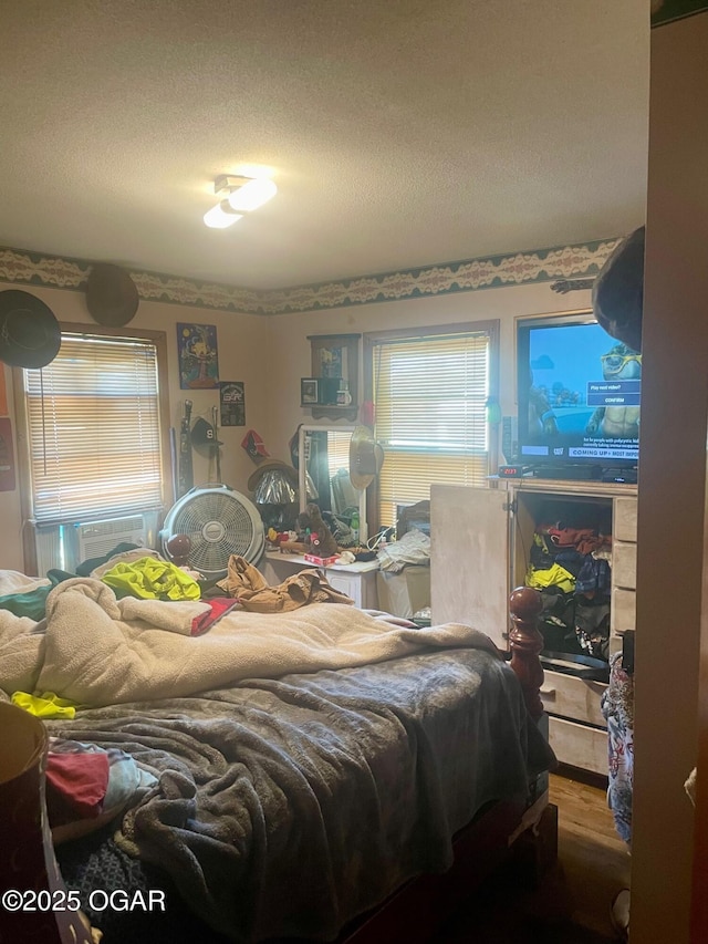 408 Beaver St, Anderson, MO 64831 - bedroom featuring a textured ceiling and wood finished floors