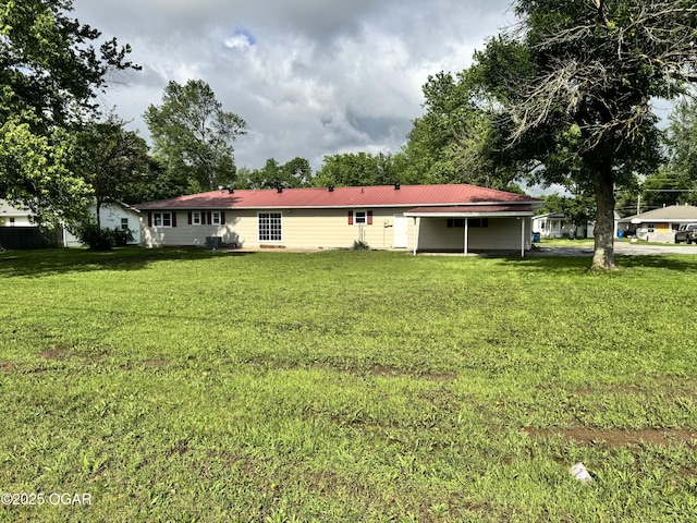2119 S Main St, Carthage, MO 64836 - back of house featuring a yard