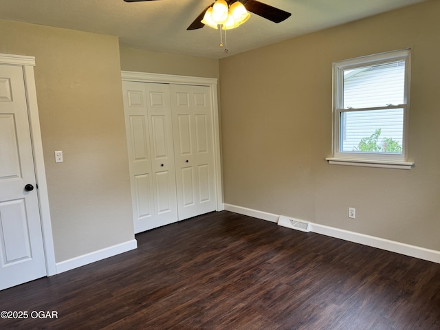 2119 S Main St, Carthage, MO 64836 - unfurnished bedroom with dark wood finished floors, baseboards, and a closet