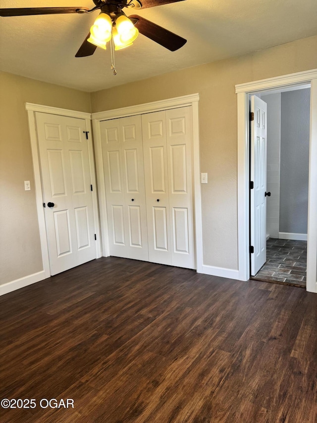 2119 S Main St, Carthage, MO 64836 - unfurnished bedroom featuring dark wood-style floors, baseboards, and a closet