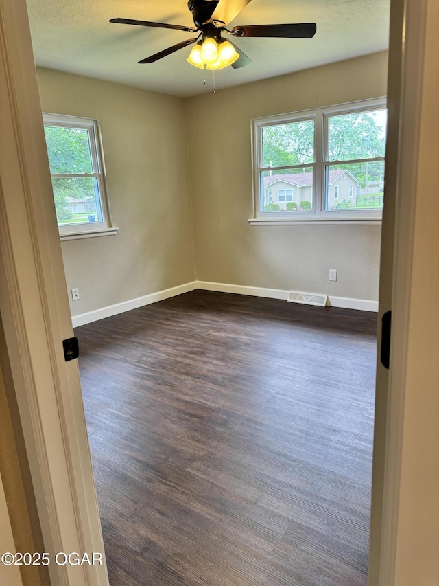 2119 S Main St, Carthage, MO 64836 - unfurnished room with a ceiling fan, dark wood-style floors, and baseboards