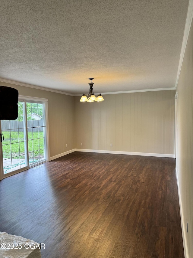 2119 S Main St, Carthage, MO 64836 - empty room with dark wood-style floors, a textured ceiling, crown molding, a chandelier, and baseboards